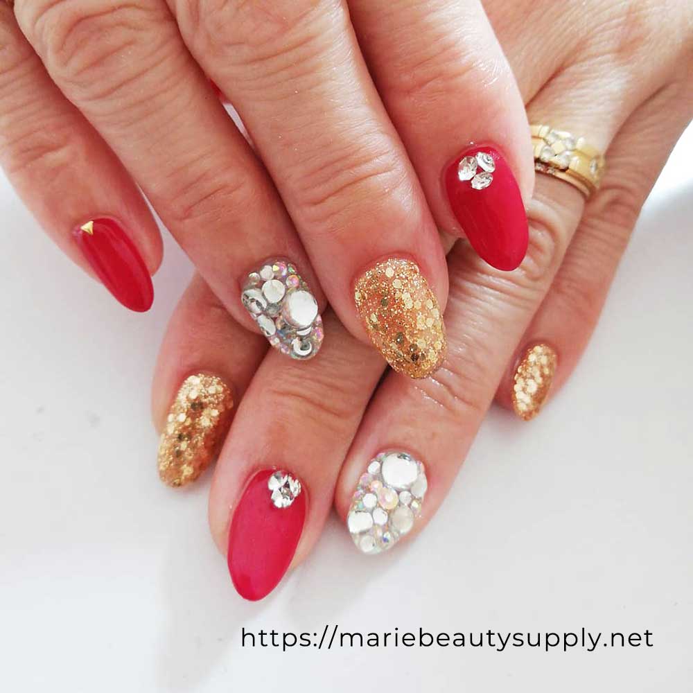 Extravagant Swarovski Nails Dressed in Red and Gold. Nail Art Gallery by MARIE BEAUTY SUPPLY.