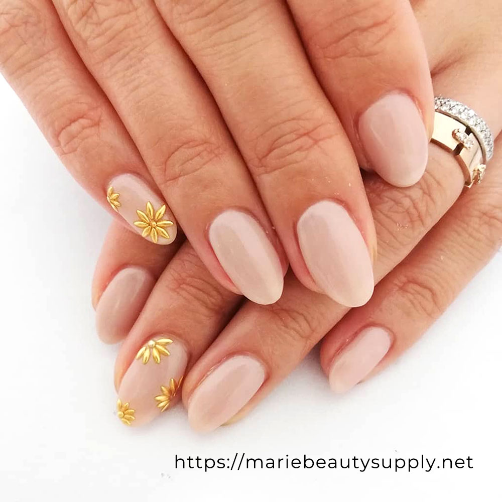 Elegant Nude with Gold Flower Nails. Nail Art Gallery by MARIE BEAUTY SUPPLY.